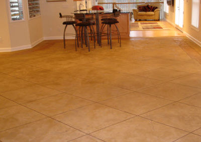 Main living floor that has square cut concrete which is stamped and stained to look like fancy tile.