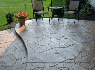Beautiful stamped patio with two levels of random sized stone shapes.
