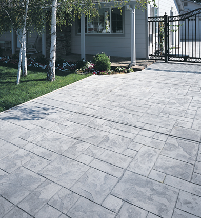 Light gray stamped concrete patio with a paver look.