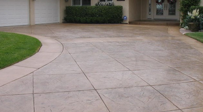Stamped concrete driveway cut into large squares.